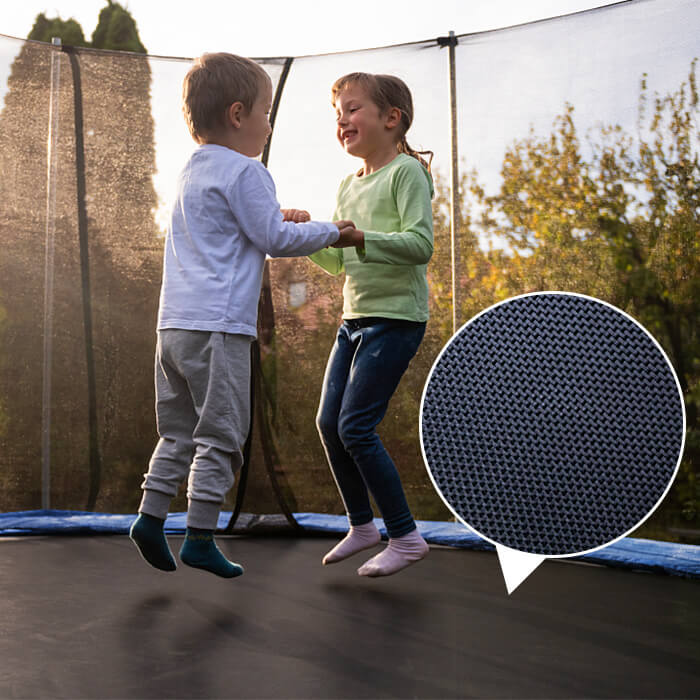 Children bouncing on 14FT Jumpfly trampoline with safety netting in outdoor setting.