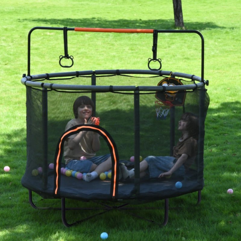 Kids playing inside 5 FT Monkey Bar Trampoline with safety net and hoop.