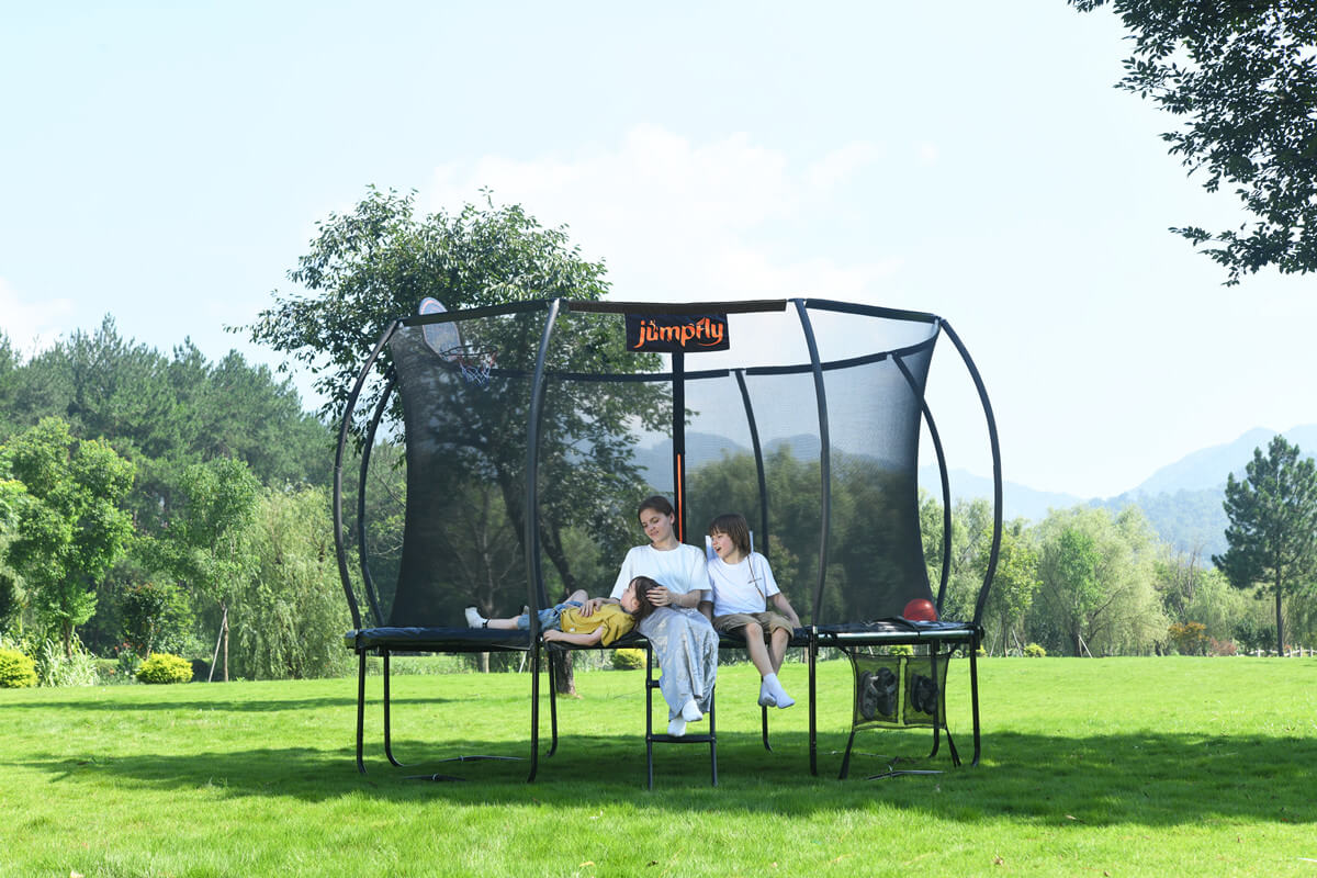 Kids and an adult have a great time on a Jumpfly outdoor trampoline