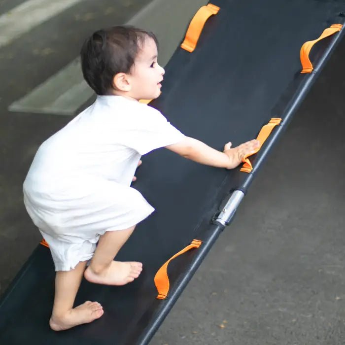 Child climbing the Jumpfly Universal Trampoline Slide, enhancing outdoor fun.